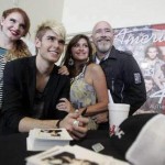 Colton Dixon signs autographs while his family looks on.